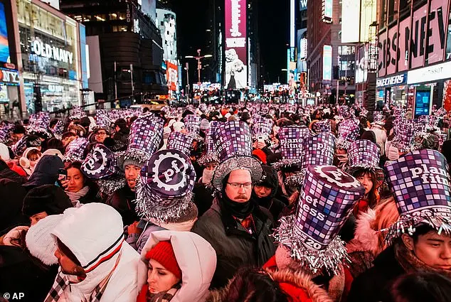 Glowing in the Cold: Times Square Revelers Celebrate New Year's Eve with Novelty Glasses and Unyielding Spirit