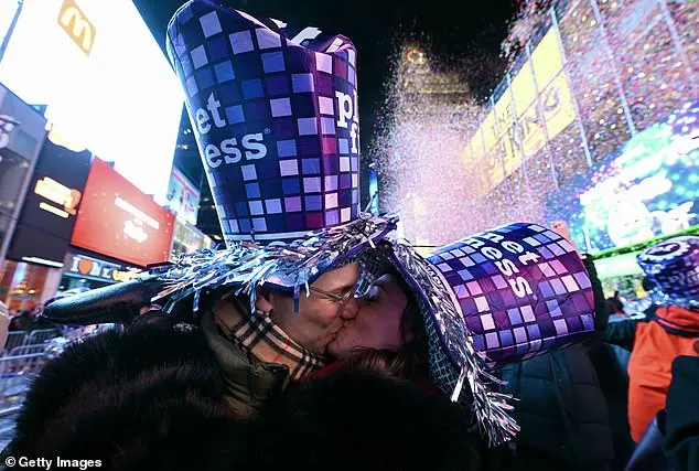Glowing in the Cold: Times Square Revelers Celebrate New Year's Eve with Novelty Glasses and Unyielding Spirit