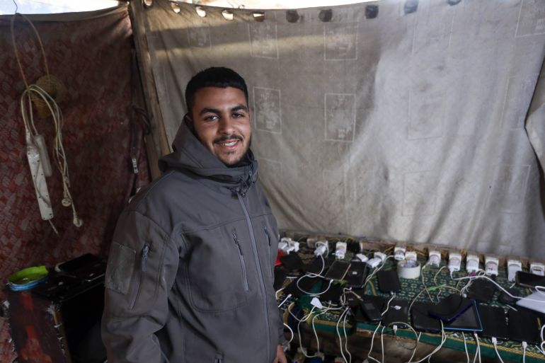 Gazans rely on phone torches for light after war destroys power grid.