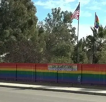 Lesbian woman discovers hateful teen group vandalizing her pride fence